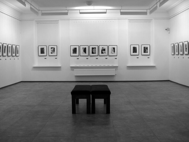 A minimalist contemporary art gallery with framed artworks on white walls, representing the galleries of Alserkal Avenue in Al Quoz, Dubai.