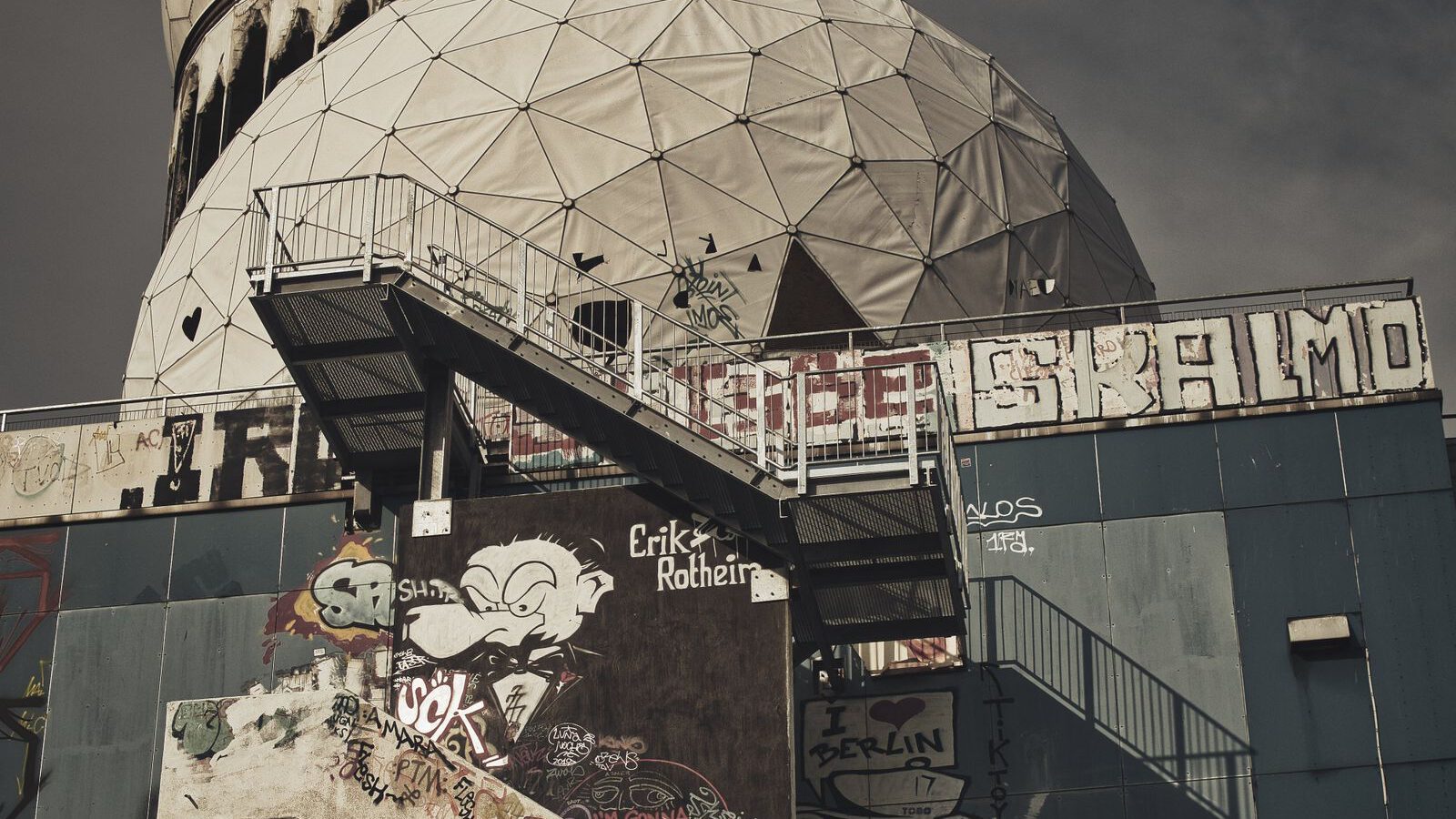 he graffiti-covered concrete building and white geodesic radar domes of the abandoned Teufelsberg listening station in Berlin.