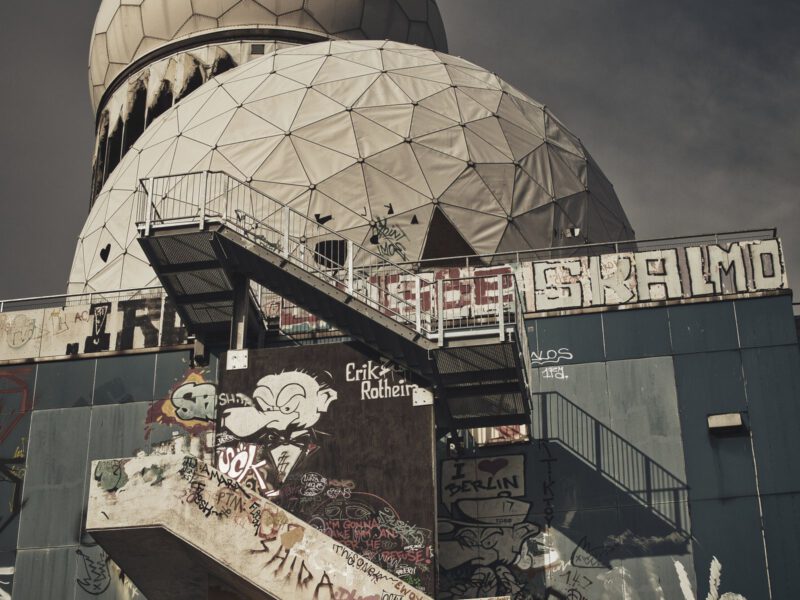 he graffiti-covered concrete building and white geodesic radar domes of the abandoned Teufelsberg listening station in Berlin.